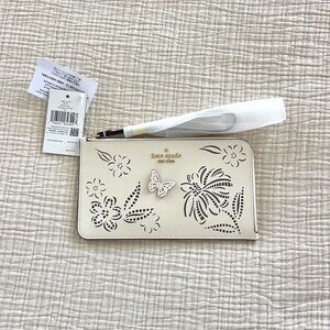 Kate spade cream colored wristlet with butterfly and flowers new